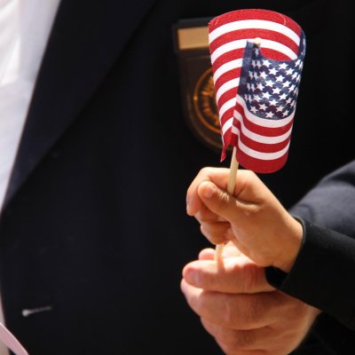 View of a veteran and child holding a small flag.