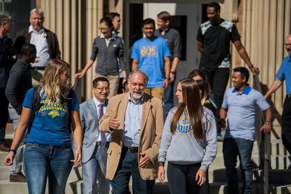 Professor walking with students