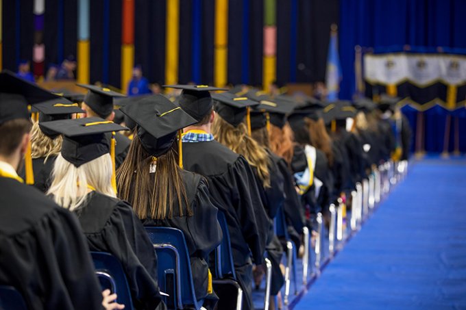 Rows of graduates at a commencement ceremony.