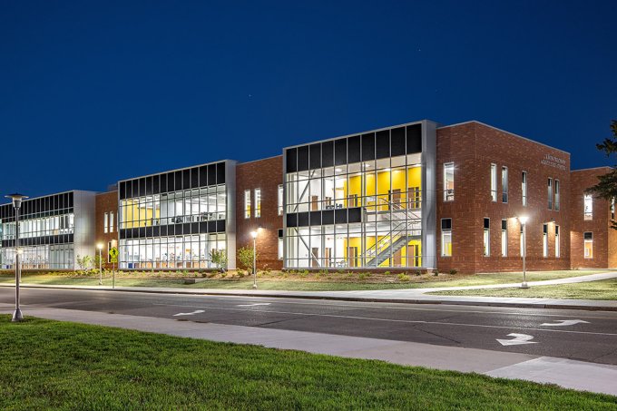 Exterior, nighttime photo of the Raven Precision Agriculture Center.
